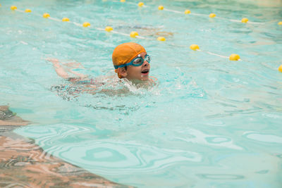 Boy swimming in pool