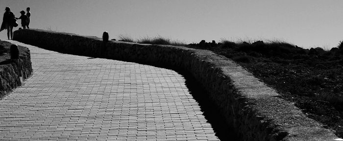 People in water against clear sky