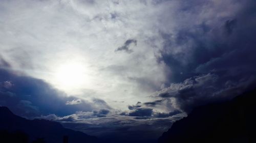 Scenic view of mountains against cloudy sky