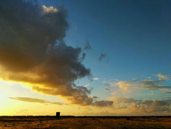 Scenic view of field against sky during sunset