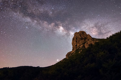 Scenic view of mountain against sky at night