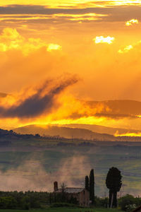 Scenic view of field against sky during sunset