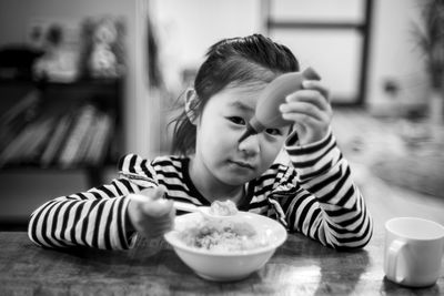 Portrait of boy eating food at home