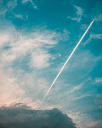 Low angle view of vapor trail in blue sky