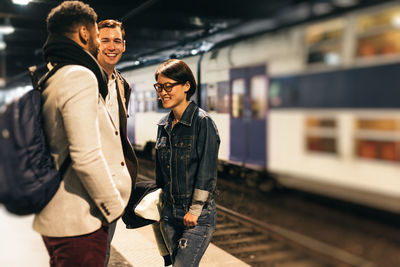 Young couple standing on railroad station