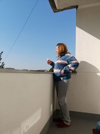 Full length of woman standing in balcony