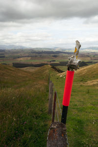 Traditional windmill on field against sky