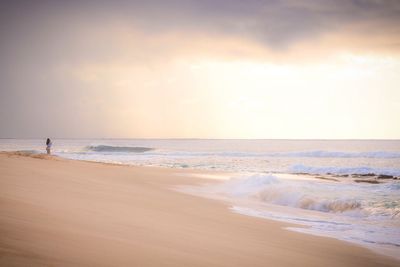 Scenic view of beach against sky during sunset