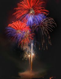 Low angle view of firework display at night