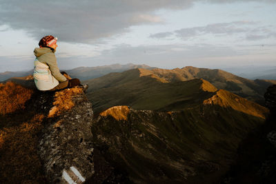 Rear view of woman standing on mountain