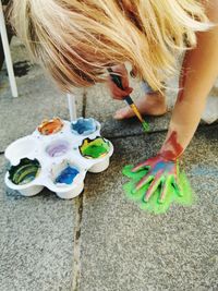 High angle view of girl playing with multi colored umbrellas