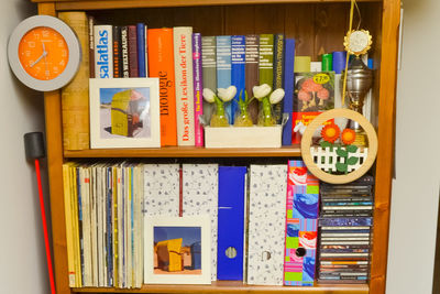 Multi colored books in shelf at home