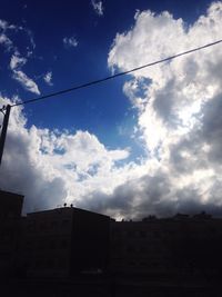 Low angle view of building against cloudy sky