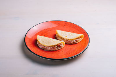 High angle view of red fruit in plate on table