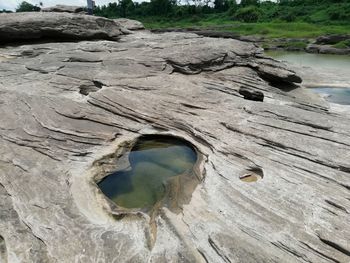 High angle view of hole on rock by lake