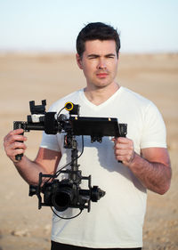 Man photographing while standing outdoors