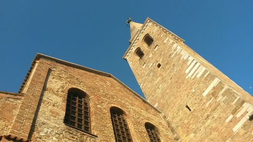 Low angle view of bell tower against blue sky