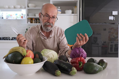 Portrait of young man holding food