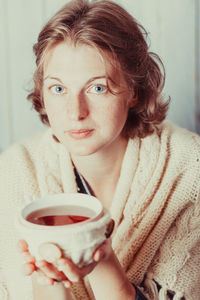 Portrait of woman drinking coffee