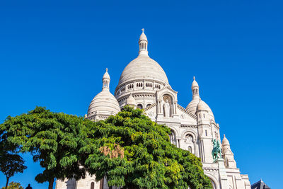 Low angle view of building against clear blue sky