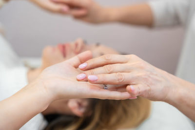 Cropped image of couple holding hands