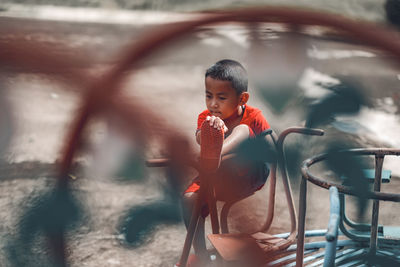 Cute boy looking through camera