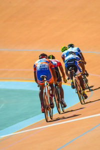 People riding bicycle by water