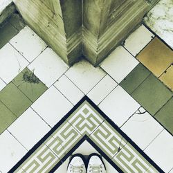 High angle view of pair of shoes on tiled floor