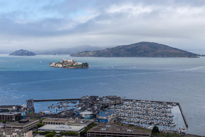 High angle view of sea and cityscape against sky