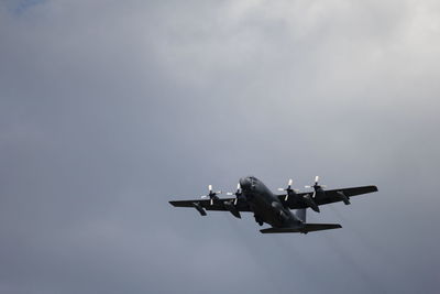 Low angle view of airplane flying against sky