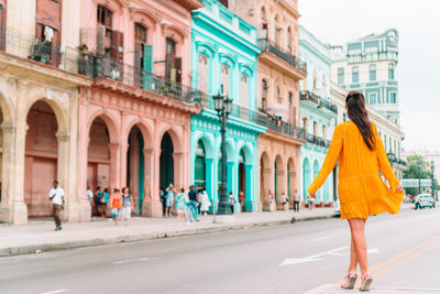 Woman walking on street in city