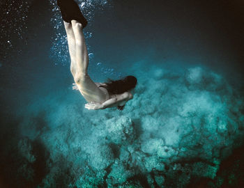 High angle view of woman swimming undersea