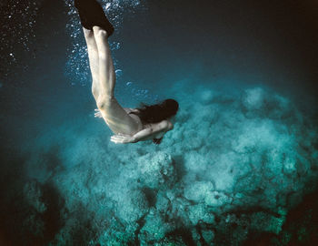 High angle view of woman swimming undersea