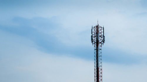 Low angle view of communications tower against sky