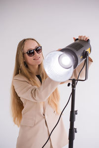 Portrait of young woman wearing sunglasses against sky