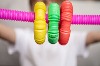 Anti stress sensory pop tube toys in a children's hands. a little kids plays with a poptube toy