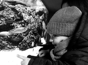 Low section of two cats lying on tiled floor