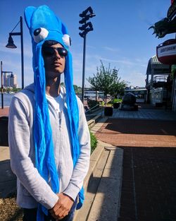 Portrait of boy wearing headdress while standing in city