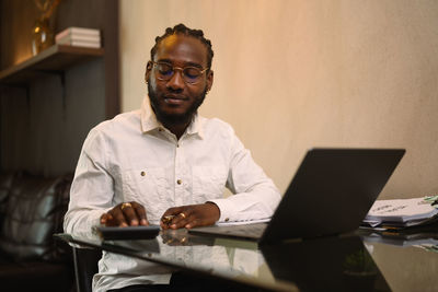 Young man using laptop at office
