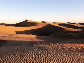 Scenic view of desert against sky during sunset