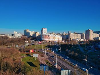 High angle view of buildings against clear blue sky