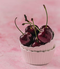 Close-up of red cherries in cupcake holder on table