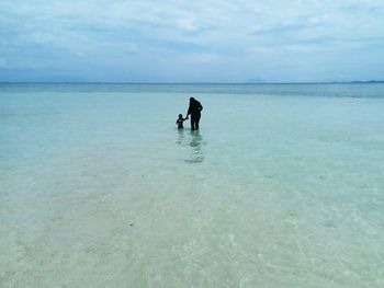Man on beach against sky