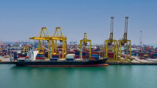 Commercial dock by pier against sky