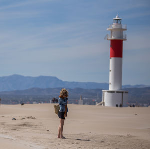 Rear view of man standing on beach