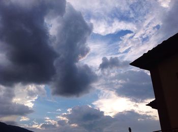 Low angle view of building against cloudy sky