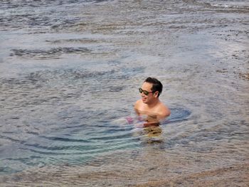 High angle view of man swimming in sea