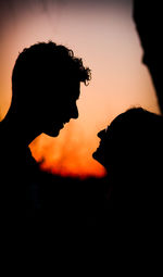 Silhouette of couple against dramatic sky
