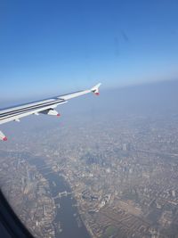 Aerial view of airplane flying in sky