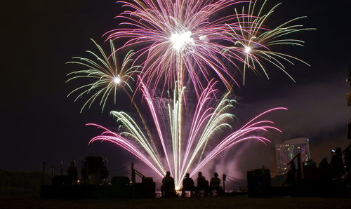 Low angle view of firework display at night